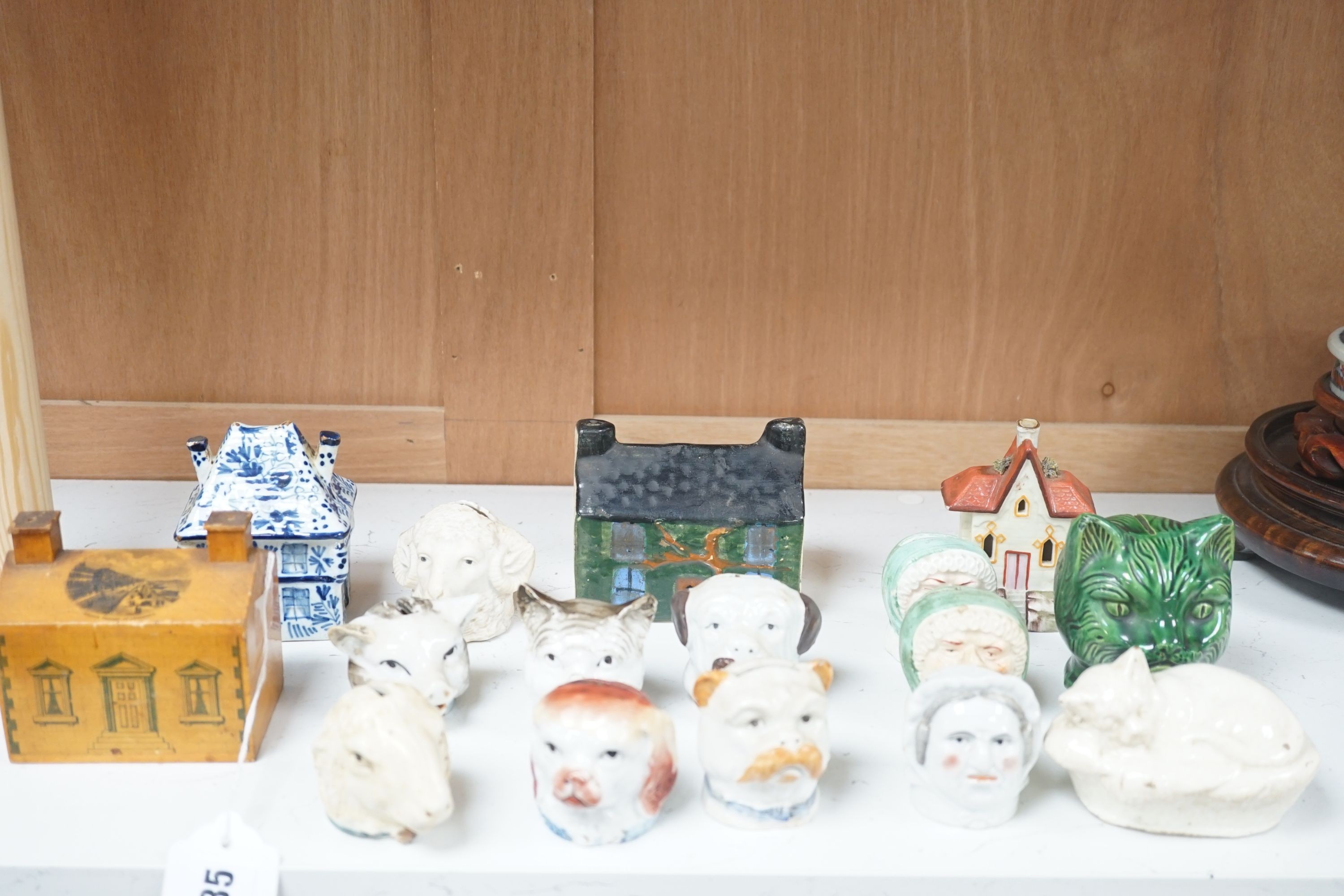 A 19th century Mauchline ware money box, together with fifteen other 19th century ceramic money boxes, Mauchline money box 8.5 cms high.